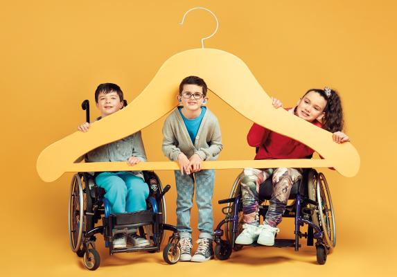 Three children with a giant hanger