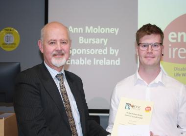 Peter Carty receiving a certificate from Enable Ireland CEO, John O'Sullivan