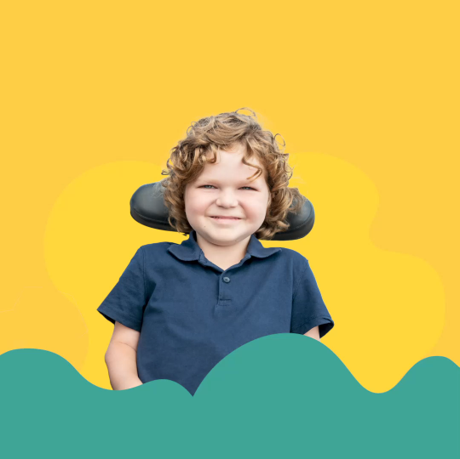 Smiling you boy who is a wheelchair user