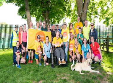 A group of people, including Robert Murray Good, dressed in yellow Enable Ireland t-shirts